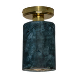 Senna Ceramic Ceiling Light in Blue Earth glaze, a cylindrical ceramic shade with dark crackled lines on a round brass ceiling canopy, shown on a plain white background.