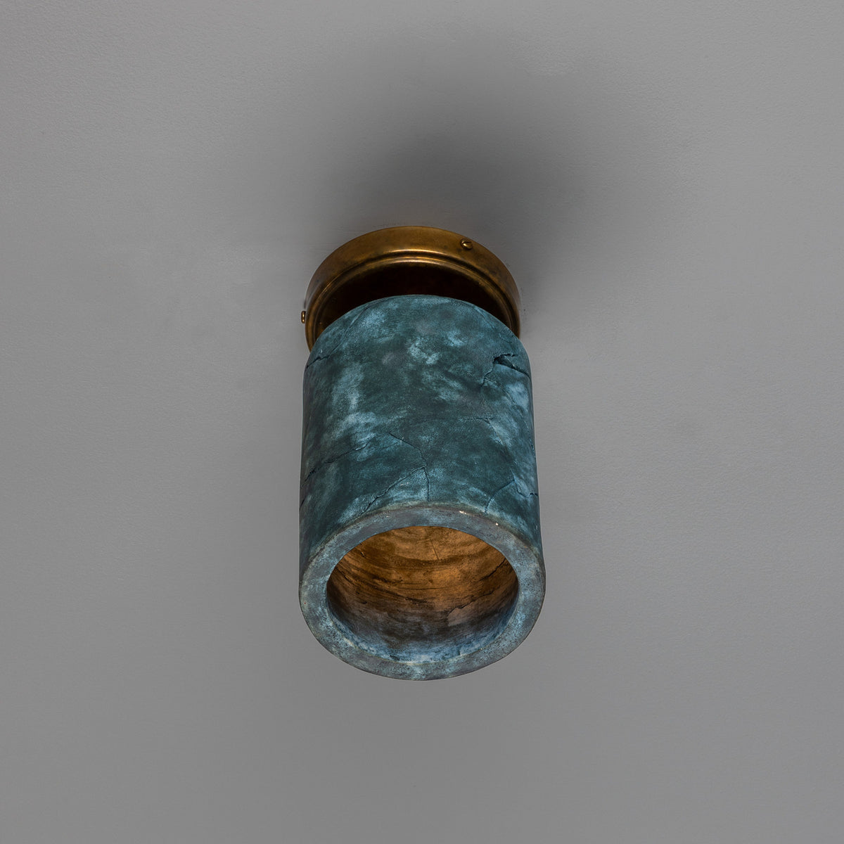 Senna Ceramic Ceiling Light in Blue Earth, a cylindrical ceramic shade with mottled blue-green glaze on a round brass ceiling canopy, shown against a plain grey background.