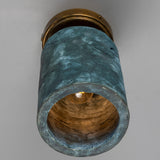 Senna Ceramic Ceiling Light in Blue Earth glaze, a cylindrical shade with fine crackled texture on a round brass ceiling canopy, shown from below with visible bulb.