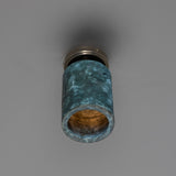 Senna Ceramic Ceiling Light in Blue Earth glaze, a cylindrical downlight shade with crackled blue-green finish on a round brass ceiling canopy, shown against a plain grey background.