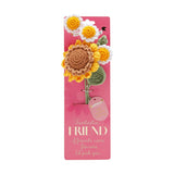 Crochet flower bundle with a yellow sunflower and three white daisies on green stems, mounted on pink "Fantastic Friend" packaging card.