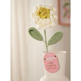 Single Stem Crochet Peony Ornament, 35cm, with curled white petals and a yellow centre on a green stem with two leaves, displayed in a white vase with a gift tag.
