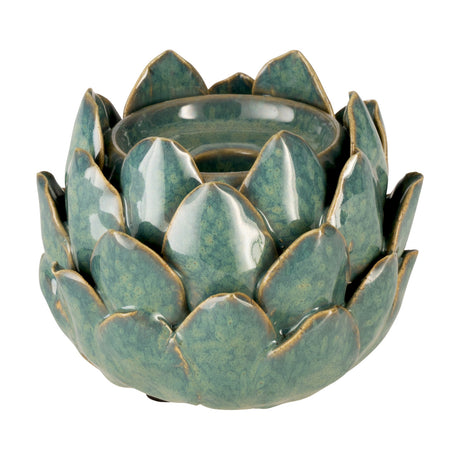 Shigay ceramic candle holder in light green, shaped like an artichoke with layered pointed petals and brown-edged detailing around a central tealight well, on a plain white background.
