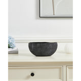 Shiguhe ceramic decorative bowl with an oval wavy rim and ribbed black and silver exterior, shown on a cream sideboard beside flowers and a framed print.
