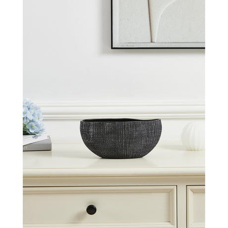 Shiguhe ceramic decorative bowl with an oval wavy rim and ribbed black and silver exterior, shown on a cream sideboard beside flowers and a framed print.