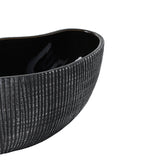 Close-up of the Shiguhe ceramic decorative bowl showing its oval wavy rim, black and silver vertical ribbed exterior, and glossy black interior, set against a plain white background.