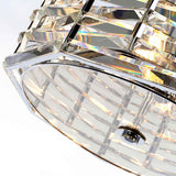 Close-up of the Shoal 4 Light Chandelier - Polished Nickel, featuring geometric glass panels and a sleek metallic framework. The light elegantly passes through the glass, creating a prismatic effect with vibrant colors, enhancing any luxury lighting setting with an exquisite touch.