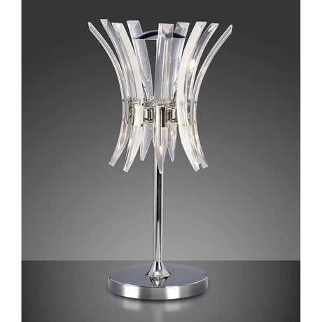 The Sinclair 4 Light Crystal Table Lamp in polished chrome features a shiny base and stand with curved, transparent acrylic pieces in a floral design—ideal for adding contemporary style to any room. Shown against a gradient gray background.