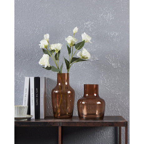 Siranana Glass Vase 19.5cm in brown with a wide bottle shape and short neck, shown with white flowers and a taller matching vase on a table.