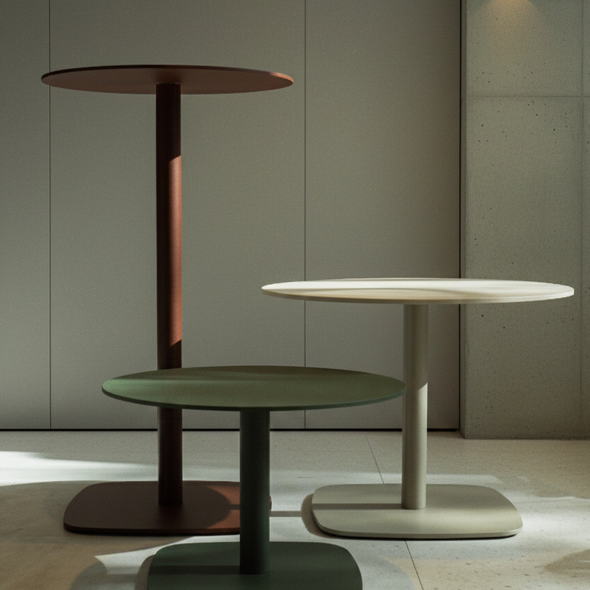 Sirkel Aluminium Outdoor Bar Table in red, white, and green, each with a round tabletop on a tall central leg and rounded square base, shown together indoors.