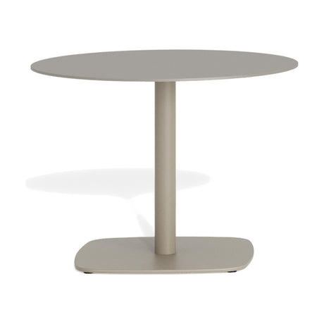 Sirkel round garden side table in beige aluminium, Ø60cm, with a slim flat top on a single central leg and rounded square steel base, shown on a plain white background.
