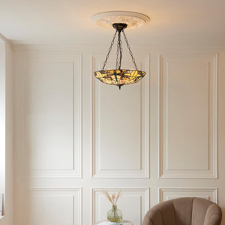 Tiffany Wrenfield 3 light inverted pendant with multicoloured leaded glass bowl shade and chain suspension, hung from a ceiling rose in a panelled living room.