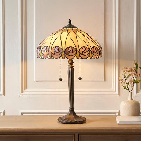 Pentleigh Large Tiffany table lamp with multicoloured leaded glass shade and slim bronze-finish metal base, styled on a wooden sideboard.