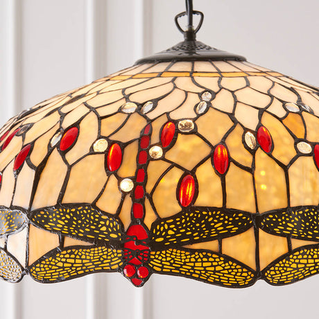 Tiffany Alderworth large 3 light pendant with leaded beige and cream glass shade featuring a dragonfly motif and red accents on a warm metal fitting.