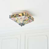 Tiffany Thornmere Medium 2 Light flush ceiling light with square multicoloured leaded glass shade and metal frame, mounted on a white panelled ceiling.