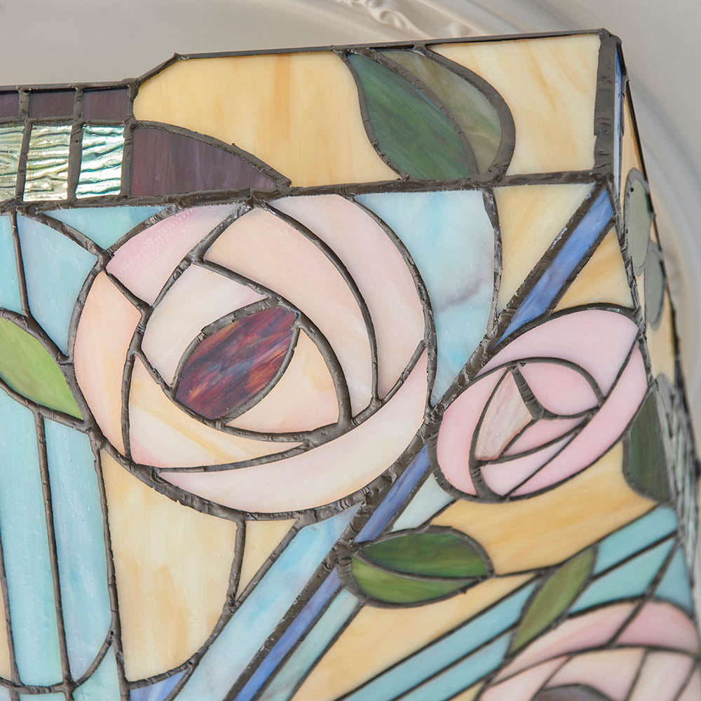 Close-up of the Tiffany Thornmere Medium 2 Light flush ceiling light, showing leaded glass panels in pink roses, green leaves, and cream and blue tones.