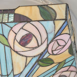 Close-up of the Tiffany Thornmere Medium 2 Light flush ceiling light, showing leaded glass panels in pink roses, green leaves, and cream and blue tones.