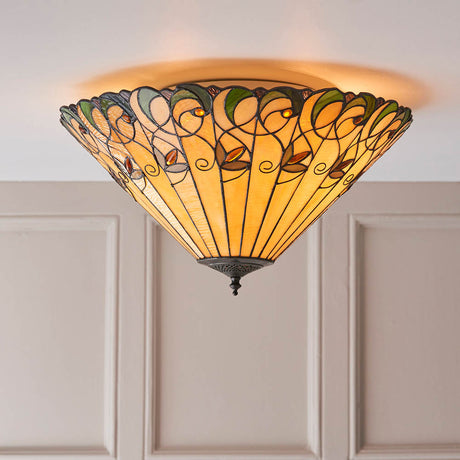 Larncombe Large 2 Light Tiffany flush ceiling light with domed multicoloured leaded glass shade, mounted on a white ceiling above panelled walls.