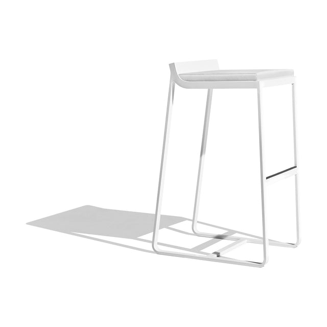 Sit Aluminium Outdoor Bar Stool with white sled-leg frame, low curved backrest, cushioned seat and footrest bar, shown on a plain white background.