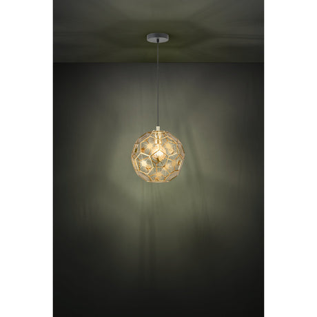 Skoura Pendant Light 30cm in Black & Brass, a steel ball-shade pendant with faceted open cutouts, hung on a black cable from a black ceiling canopy against a dark wall.
