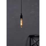 Pendant light fitted with a Smart Amber LED Bulb E27, its slim glass tube showing X-shaped filaments glowing warm white, hung against a dark textured wall.