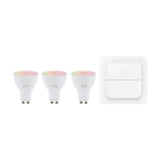 Pack of 3 Smart Colour Changing LED Bulbs, GU10 fitting, white body with frosted lens, shown beside a white wall-mounted smart switch on a plain background.