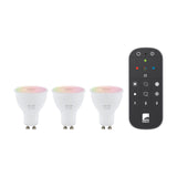 Three white GU10 smart LED bulbs with colour-changing tops shown alongside a black handheld remote with coloured buttons, on a plain white background.