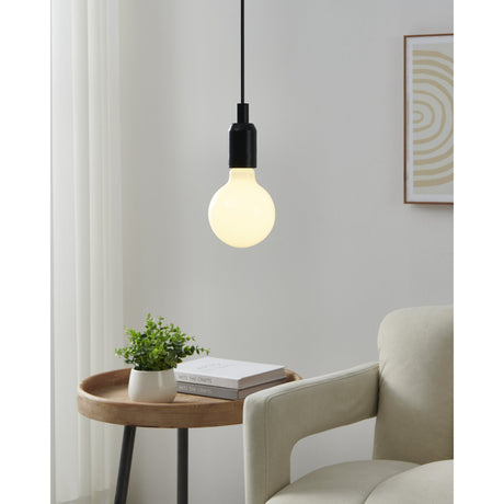Smart Colour Changing Opal LED Globe Bulb E27 G95 7.5W glowing warm white on a black pendant cord above a side table in a living room setting.
