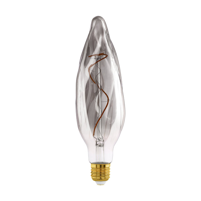 Smoked dimmable LED bulb with tall rippled flame-shaped glass, visible spiral filament and brass E27 screw cap, shown against a plain white background.