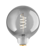 Smoked LED globe bulb G125 with spiral filament and E27 brass-coloured screw cap, shown lit against a plain white background.