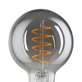 Smoked glass LED globe bulb (G80, E27) with a spiral amber filament visible inside, showing a dark transparent tint and gold screw cap against a plain white background.