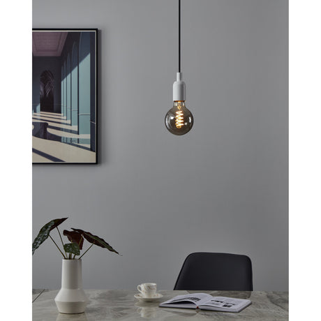 Smoked Dimmable LED Globe Bulb E27 G95 4W, pendant-mounted on a white fitting in a grey dining room, glass sphere with glowing spiral filament.
