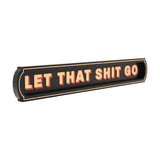 Black wooden wall plaque reading "LET THAT SHIT GO" in bold cream capitals with red drop shadow, set in a recessed panel with fine cream border, shown on a plain white background.