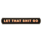 Black wooden wall plaque reading "LET THAT SHIT GO" in bold cream capitals with red drop shadow, set in a recessed panel with a fine cream outline, on a plain white background.