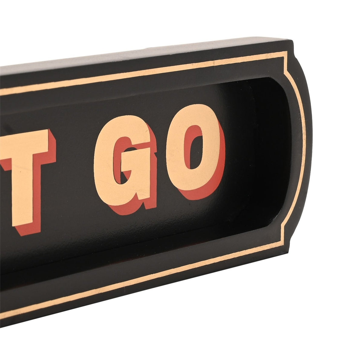 Close-up of the "Let That Shit Go" black wooden wall plaque, showing cream capital lettering with red drop shadow in a recessed panel with a fine cream border, shaped rounded end.