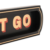 Close-up of the "Let That Shit Go" black wooden wall plaque, showing cream capital lettering with red drop shadow in a recessed panel with a fine cream border, shaped rounded end.