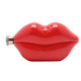 Glossy red steel hip flask shaped like pouting lips, 5oz capacity, with a knurled silver screw cap at one corner, shown on a plain white background.