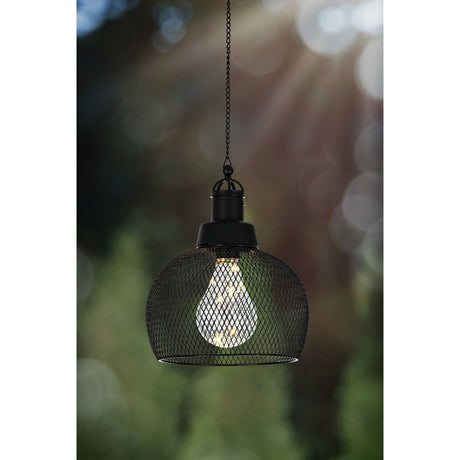 Solar Lantern 18.5cm in black, a hanging dome of black wire mesh with an integrated LED bulb insert, suspended on a fine chain outdoors against a blurred garden background.