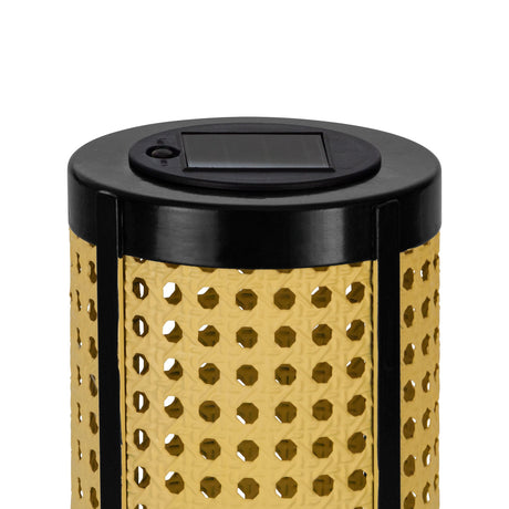 Close-up of the Solar LED Table Lamp's black top with integrated solar panel, above a cylindrical shade with cane-style pierced pattern in beige, set on a plain white background.