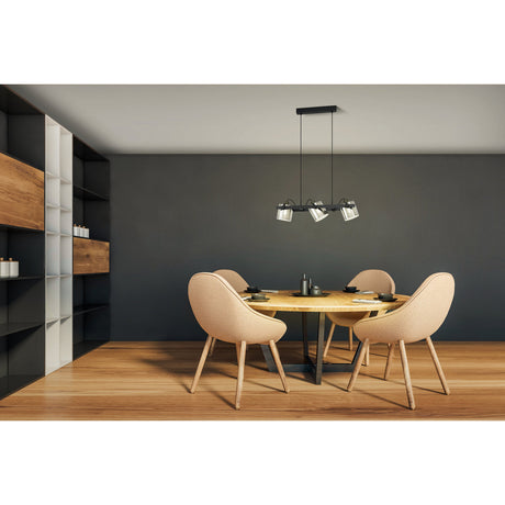 Sonanne 3-light linear pendant with smoked glass shades on a black bar, suspended over a round wood dining table in a modern dining room.