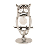 Chrome plated perched owl figurine with open silver outline body, tufted ears, round eyes, and a faceted crystal centrepiece, set on a round base against a plain white background.