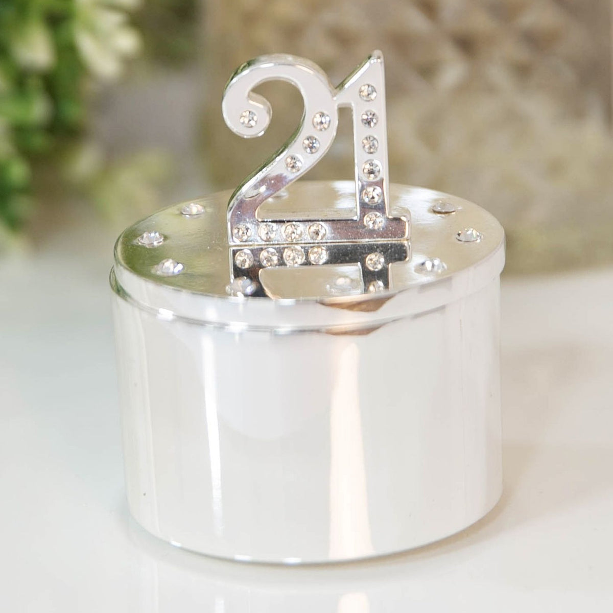 Round silverplated trinket box with a crystal "21" numeral standing on the lid, surrounded by scattered crystals, polished silver finish, shown on a light background.