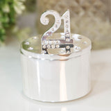 Round silverplated trinket box with a crystal "21" numeral standing on the lid, surrounded by scattered crystals, polished silver finish, shown on a light background.