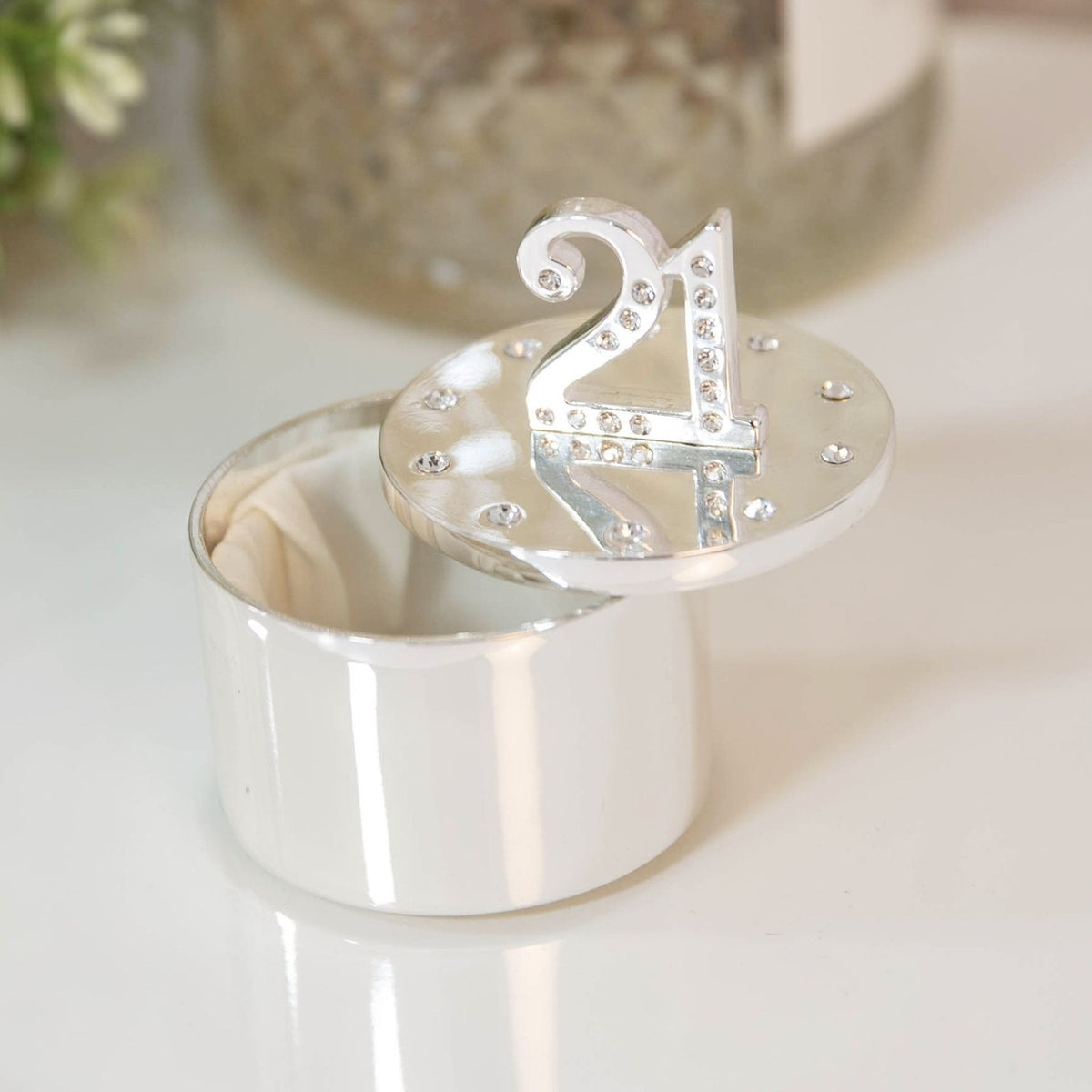 Round silverplated trinket box with a crystal "21" raised on the lid and crystals ringed around the edge, shown open with a cream satin lining.