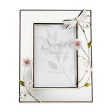 Rectangular 6x4in photo frame with pale glass border and silver wire trim, featuring a white hand-painted dragonfly, pink-centred flowers and green leaves, on a plain white background.