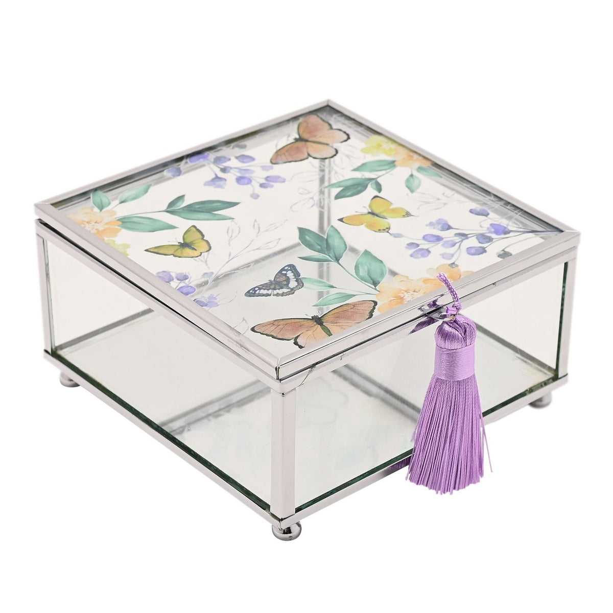 Square glass trinket box with silver-tone frame, lid featuring butterflies among leaves and purple florals, clear sides and a purple tassel on the front clasp.