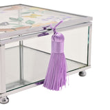 Close-up of the Butterfly Glass Trinket Box with Tassel in Clear & Purple, showing the silver-tone frame, clear glass side panel, and purple tassel detail on a white background.