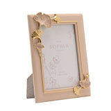 Classic Ginkgo resin photo frame in blush pink with gold and pink gingko leaf accents at opposite corners, slim gold inner edge, 4" x 6" aperture, shown on a plain white background.
