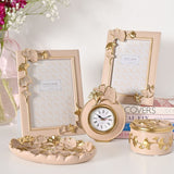 Classic Ginkgo Resin Photo Frames in pink with gold and pink leaf details, shown with a matching clock, trinket box and tray in a home decor display.