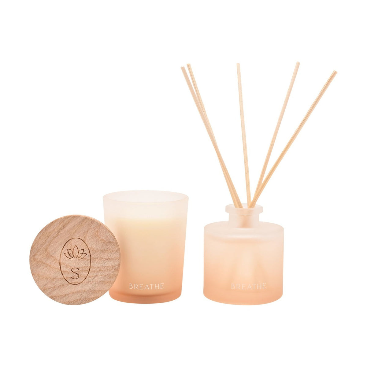 Breathe frosted candle and reed diffuser set in off white, with a wooden lotus-engraved lid, gradient glass vessels, and slim reeds, shown on a plain white background.